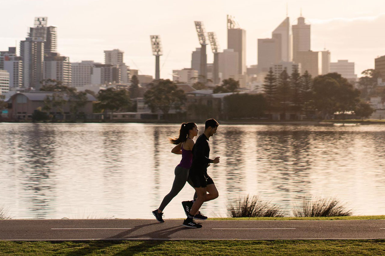 Two runners enjoy a morning run along the Swan River